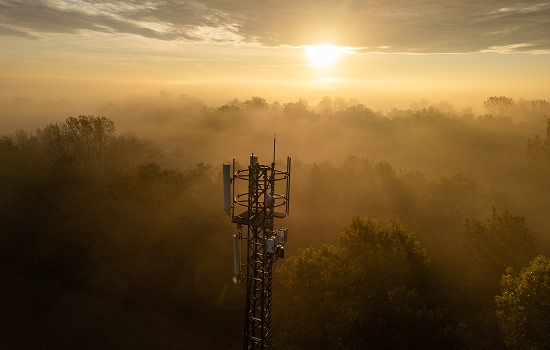 Top of a communication tower with sunrise in the background.