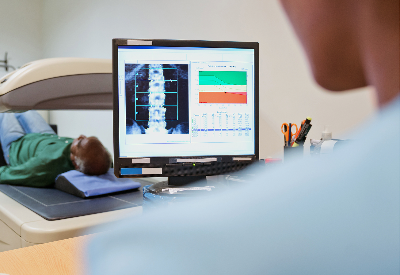 Medical scan with X-ray results on screen.