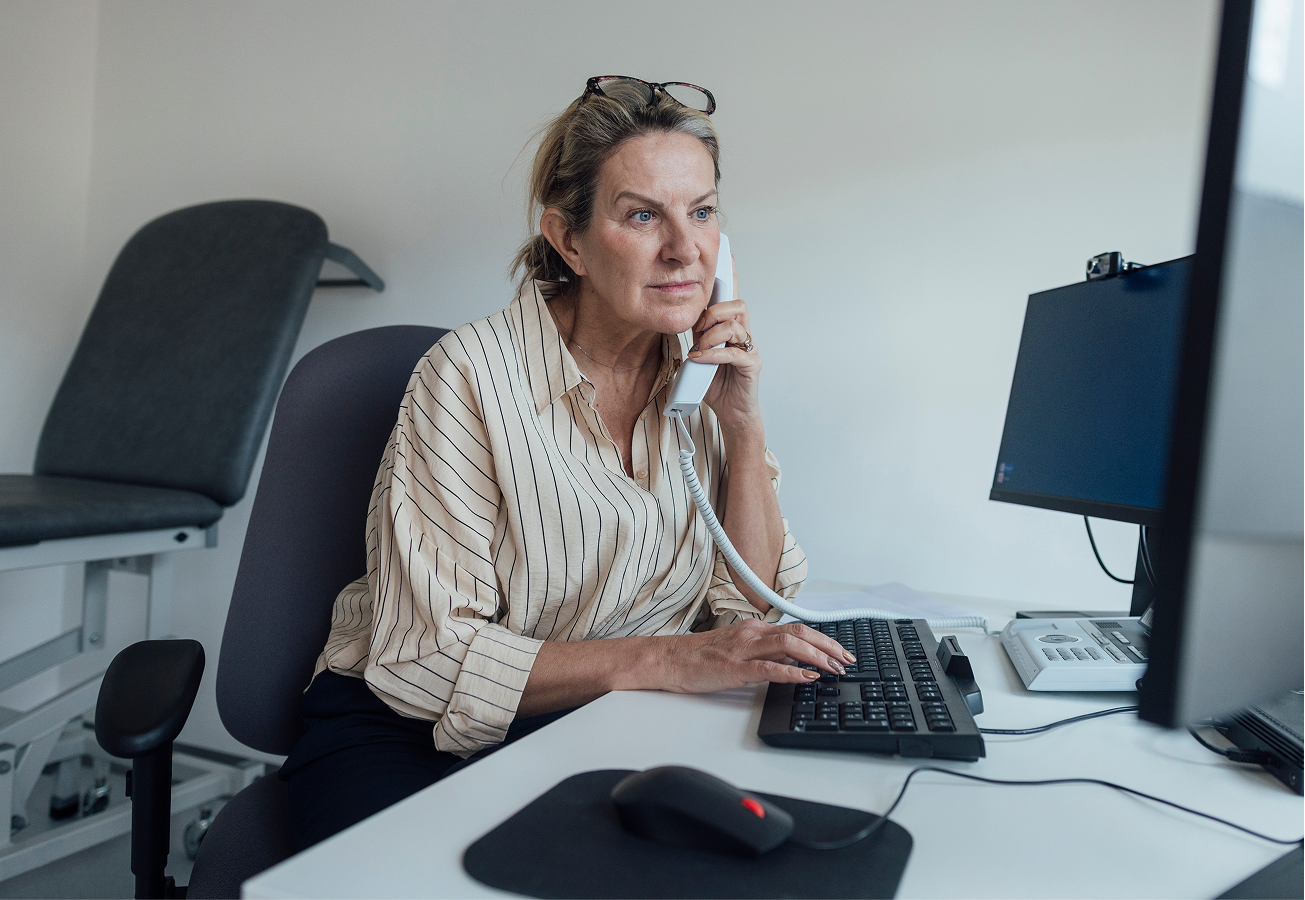 GP in the office on the phone.