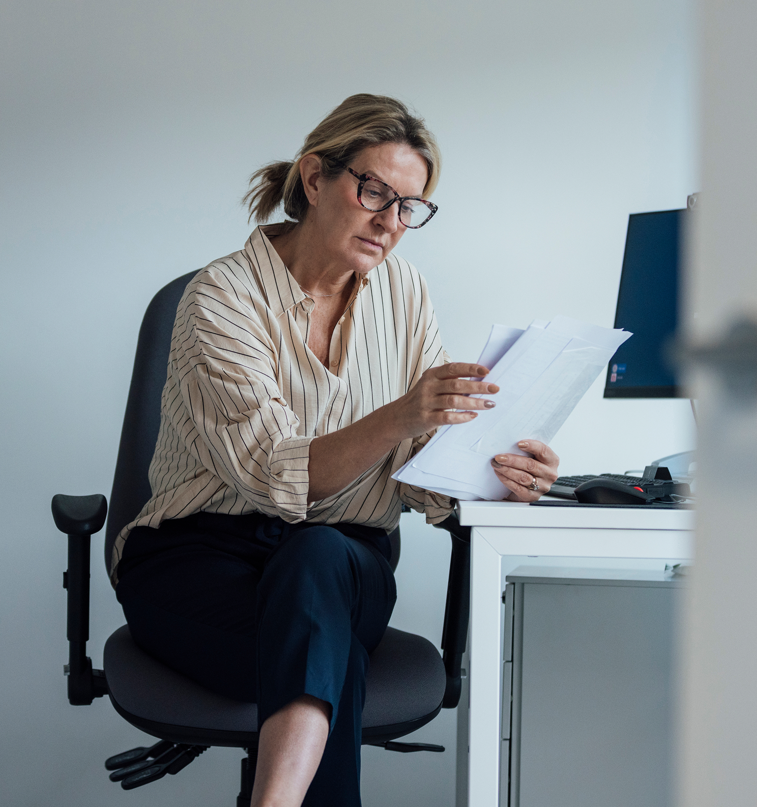 GP in the office on the phone.