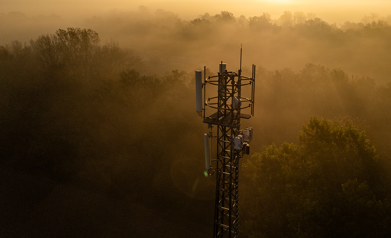 Top of a communication tower with sunrise in the background.