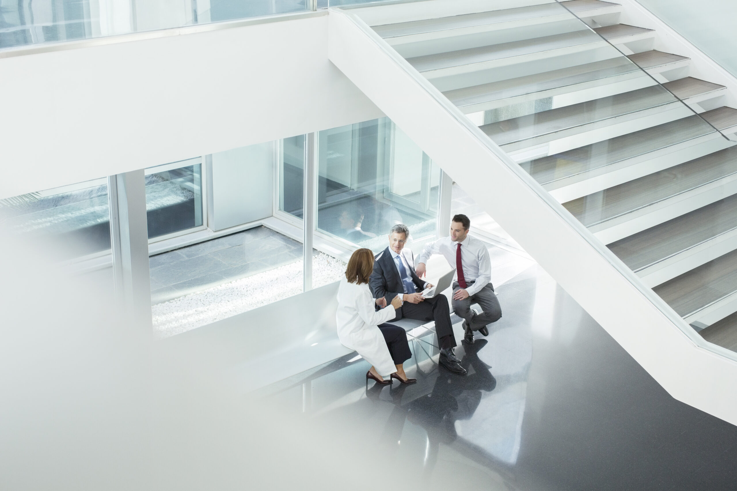 Doctor and administrators talking in hospital lobby