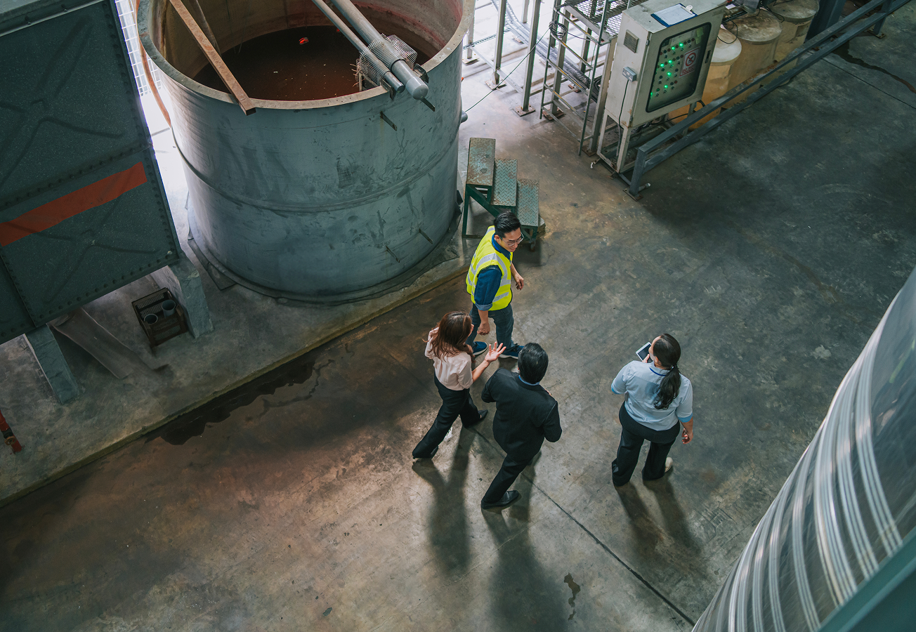 A group of people working through manufacturing plant.